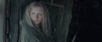 Movie still from “Hanna” (2011), directed by Joe Wright – A woman with long blonde hair and blue eyes looking at the camera; Close Up shot, High angle