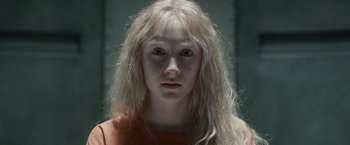 Movie still from “Hanna” (2011), directed by Joe Wright – A woman with long white hair and a red shirt; Close Up shot, High angle