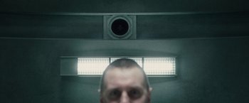Movie still from “Hanna” (2011), directed by Joe Wright – A man standing in front of an air vent; Extreme Close Up shot, Overhead angle