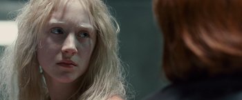 Movie still from “Hanna” (2011), directed by Joe Wright – A woman with long blonde hair looking at the camera; Close Up shot, Over the shoulder angle