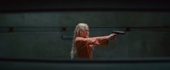 Movie still from “Hanna” (2011), directed by Joe Wright – A woman holding a gun in her hand; Medium shot, Low angle
