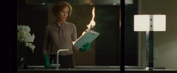 A woman in a green glove holding an ipad