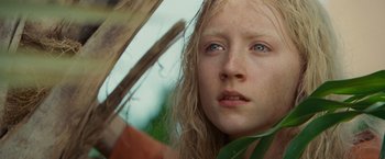 Movie still from “Hanna” (2011), directed by Joe Wright – A person with long blonde hair; Close Up shot, Low angle