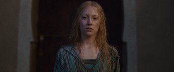 Movie still from “Hanna” (2011), directed by Joe Wright – A woman with blonde hair is standing in the dark; Close Up shot, Low angle