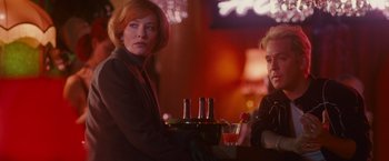 Movie still from “Hanna” (2011), directed by Joe Wright – Two women sitting at a bar with drinks on a tray; Medium shot, Low angle