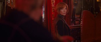 Movie still from “Hanna” (2011), directed by Joe Wright – A woman standing in front of a red curtain; Medium shot, Over the shoulder angle