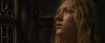 Movie still from “Hanna” (2011), directed by Joe Wright – A person with long blonde hair; Close Up shot, Low angle
