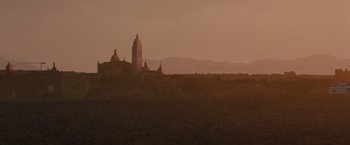 Movie still from “Hanna” (2011), directed by Joe Wright – A view of a town with a church in the background; Extreme Wide shot, Low angle