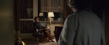 Movie still from “Hanna” (2011), directed by Joe Wright – A woman sitting in a chair in front of another woman; Wide shot, Over the shoulder angle