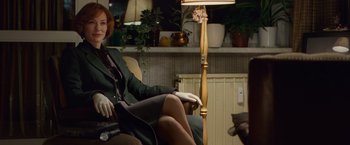 Movie still from “Hanna” (2011), directed by Joe Wright – A woman sitting in a chair next to a floor lamp; Medium shot, Over the shoulder angle