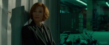 Movie still from “Hanna” (2011), directed by Joe Wright – A woman with short red hair sitting in front of a window; Close Up shot, Over the shoulder angle