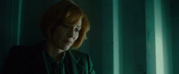 Movie still from “Hanna” (2011), directed by Joe Wright – A woman with red hair sitting in front of a window; Close Up shot, Over the shoulder angle