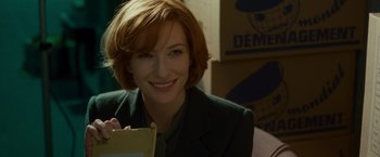 Movie still from “Hanna” (2011), directed by Joe Wright – A woman with red hair holding a piece of paper; Close Up shot, Over the shoulder angle