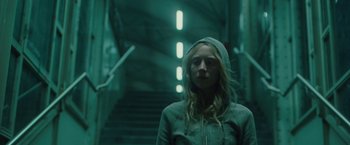 Movie still from “Hanna” (2011), directed by Joe Wright – A woman standing in front of some stairs; Medium shot, Low angle