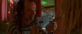 Movie still from “Hanna” (2011), directed by Joe Wright – A man holding an envelope in his hands; Close Up shot, Low angle