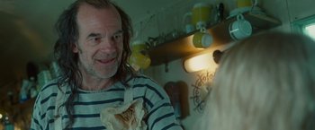 Movie still from “Hanna” (2011), directed by Joe Wright – A man holding a piece of food in his hand; Close Up shot, Over the shoulder angle