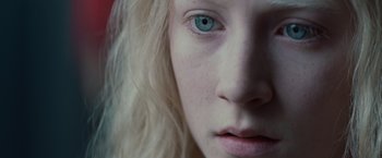 Movie still from “Hanna” (2011), directed by Joe Wright – A woman's face with blue eyes; Extreme Close Up shot, Overhead angle