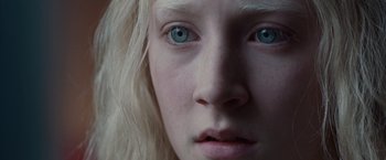 A person's face with blue eyes