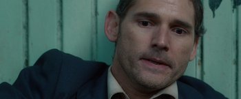 Movie still from “Hanna” (2011), directed by Joe Wright – A person wearing a suit and tie; Close Up shot, High angle