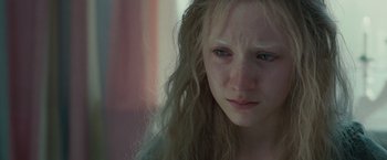 Movie still from “Hanna” (2011), directed by Joe Wright – A woman with long blonde hair stares into the camera; Close Up shot, High angle