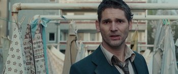 Movie still from “Hanna” (2011), directed by Joe Wright – A person wearing a suit and tie; Close Up shot, Over the shoulder angle