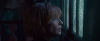 Movie still from “Hanna” (2011), directed by Joe Wright – A person looking out of a window; Close Up shot, Low angle