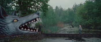 Movie still from “Hanna” (2011), directed by Joe Wright – A man standing next to an animal head on a rail road track; Extreme Wide shot, High angle