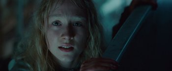 Movie still from “Hanna” (2011), directed by Joe Wright – A young girl with long blonde hair holding a knife in her hand; Close Up shot, Low angle