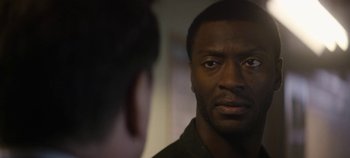 Movie still from “Black Mirror” (2011), created by Charlie Brooker – A person looking at a mirror; Close Up shot, Over the shoulder angle