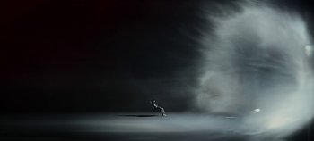 Movie still from “Black Mirror” (2011), created by Charlie Brooker – A person sitting on the ground in a dark room; Extreme Wide shot, Low angle