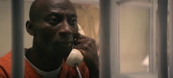Movie still from “Black Mirror” (2011), created by Charlie Brooker – A person talking on a phone; Close Up shot, High angle