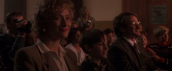 Movie still from “Hook” (1991), directed by Steven Spielberg – A group of people sitting in a room; Close Up shot, Over the shoulder angle