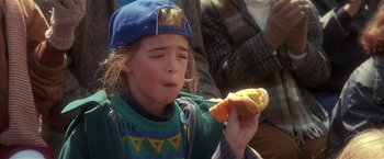 Movie still from “Hook” (1991), directed by Steven Spielberg – A little girl eating a hot dog on top of a bun; Close Up shot, High angle
