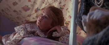 Movie still from “Hook” (1991), directed by Steven Spielberg – A little girl laying in bed with her head resting on a pillow; Close Up shot, High angle