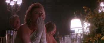 Movie still from “Hook” (1991), directed by Steven Spielberg – A woman in a white dress sitting at a dinner table; Close Up shot, Over the shoulder angle