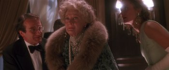 Movie still from “Hook” (1991), directed by Steven Spielberg – An older woman wearing a fur coat and a necklace; Close Up shot, Low angle