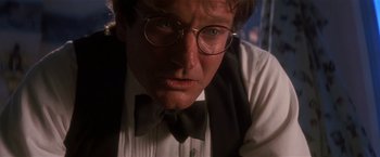 Movie still from “Hook” (1991), directed by Steven Spielberg – A person wearing glasses and a bow tie; Close Up shot, Low angle
