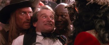 Movie still from “Hook” (1991), directed by Steven Spielberg – A man and a man in a crowd of people; Close Up shot, Low angle
