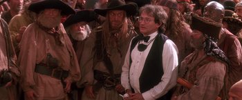 Movie still from “Hook” (1991), directed by Steven Spielberg – A group of men standing next to each other; Medium shot, Over the shoulder angle