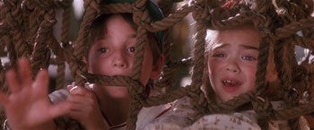 Movie still from “Hook” (1991), directed by Steven Spielberg – Two young children with ropes around their faces; Close Up shot, Low angle