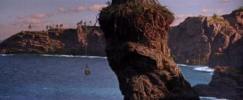 Movie still from “Hook” (1991), directed by Steven Spielberg – A rope hanging from a rock near the ocean; Extreme Wide shot, High angle