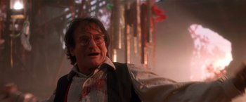 Movie still from “Hook” (1991), directed by Steven Spielberg – A person wearing glasses and a tie; Close Up shot, Low angle