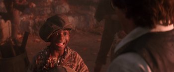 Movie still from “Hook” (1991), directed by Steven Spielberg – A young boy with a hat and a smile; Close Up shot, High angle