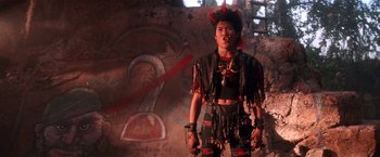 Movie still from “Hook” (1991), directed by Steven Spielberg – A man in a costume standing in front of a wall; Medium shot, Low angle