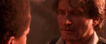 Movie still from “Hook” (1991), directed by Steven Spielberg – A man's face in the sunlight; Close Up shot, Over the shoulder angle