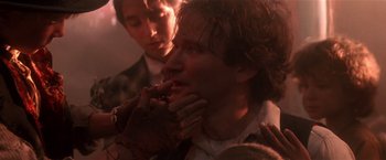 Movie still from “Hook” (1991), directed by Steven Spielberg – A man with his hand in his mouth and another man standing next to him; Close Up shot, Over the shoulder angle