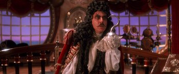 Movie still from “Hook” (1991), directed by Steven Spielberg – A man dressed as a pirate holding an umbrella; Close Up shot, Over the shoulder angle