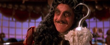 Movie still from “Hook” (1991), directed by Steven Spielberg – A person wearing a wig; Close Up shot, Over the shoulder angle