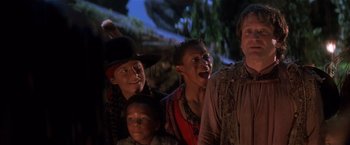 Movie still from “Hook” (1991), directed by Steven Spielberg – A group of people standing next to each other; Medium shot, Low angle