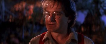 Movie still from “Hook” (1991), directed by Steven Spielberg – A person wearing glasses; Close Up shot, Over the shoulder angle